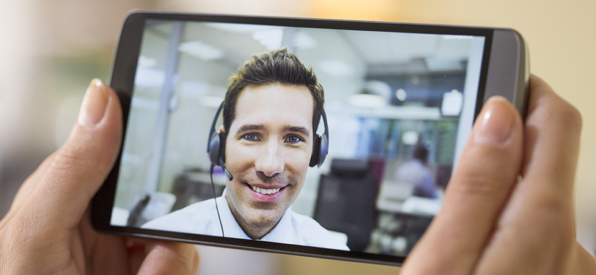 Closeup of a female hand holding a smart phone during a skype vi